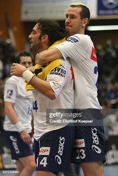 Bertrand Gille and Pascal Hens of Hamburg celebrate the 33-29 victory after the Bundesliga match between VfL Gummersbach and HSV Hamburg at the...
