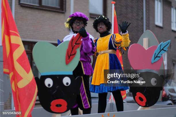 People dressed as Zwarte Piet or Black Pete, attend a parade with Sinterklaas November 24 in Katwijk, Netherlands. Recently, the traditional...