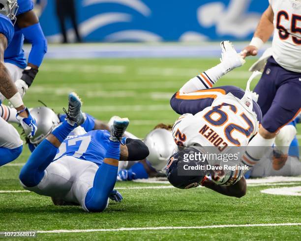 Tarik Cohen of the Chicago Bears is tackled by Glover Quin of the Detroit Lions during an NFL, Thanksgiving Day game at Ford Field on November 22,...