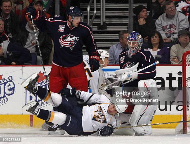 Jordin Tootoo of the Nashville Predators is dumped by Jan Hejda of the Columbus Blue Jackets at the Nationwide Arena on December 1, 2010 in Columbus,...