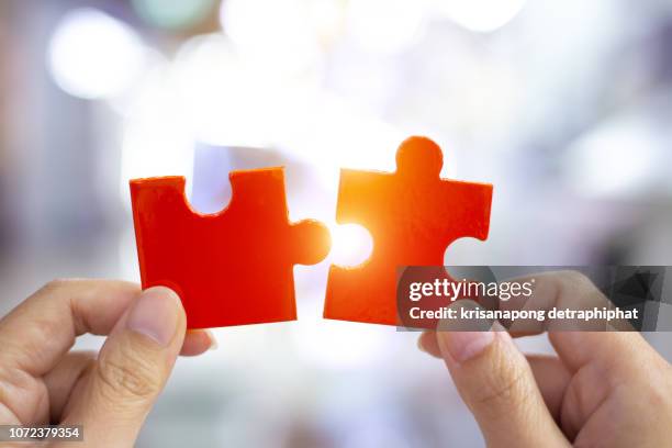 success and strategy concept. business woman hand connecting jigsaw puzzle. - abstract partnership stock pictures, royalty-free photos & images