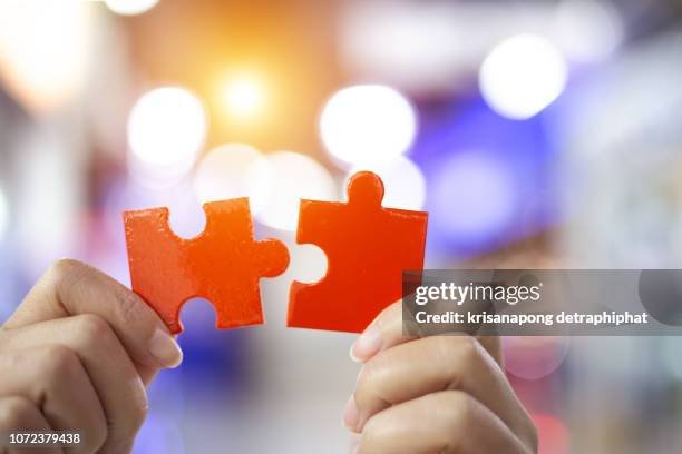 success and strategy concept. business woman hand connecting jigsaw puzzle. - marketing tools stock pictures, royalty-free photos & images