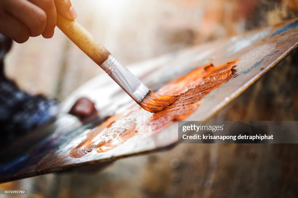 Artist hand with brush painting