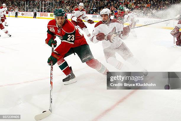 Eric Nystrom of the Minnesota Wild skates with the puck while David Schlemko of the Phoenix Coyotes defends during the game at the Xcel Energy Center...