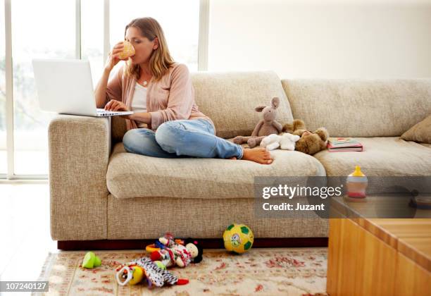 woman working on computer at home  - australian cup day stock pictures, royalty-free photos & images