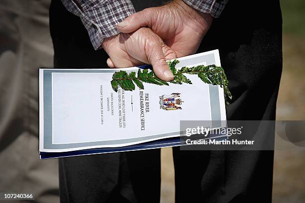 Man holds a copy of the Pike River Mine Official Remembrance Service booklet at a national memorial service for the 29 miners that lost their lives...