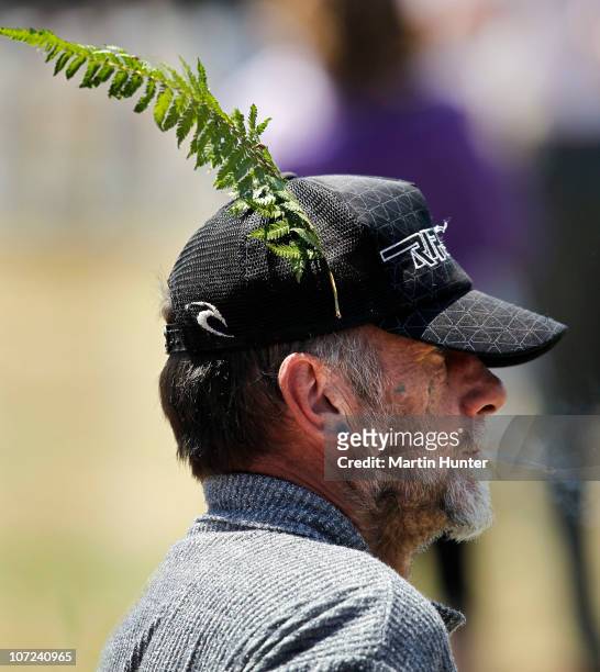 Man wears a native fern on his hat during a national memorial service for the 29 miners that lost their lives in the Pike River Mine at Omoto...