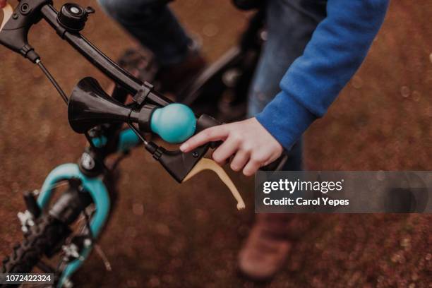 closeup hands and handlebar of a young biker on street - bike handle stock pictures, royalty-free photos & images