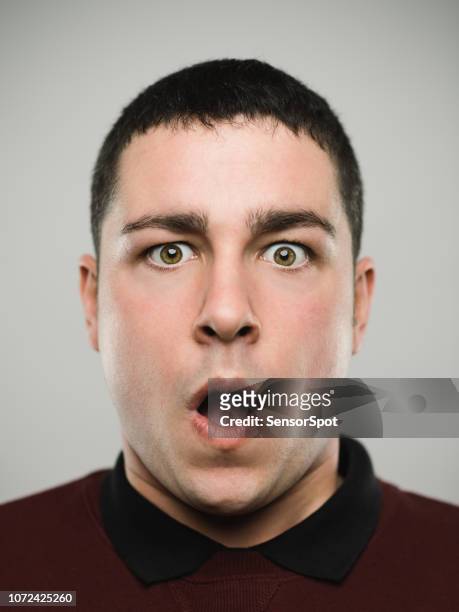 portrait of a surprised young caucasian man. - worried face stock pictures, royalty-free photos & images