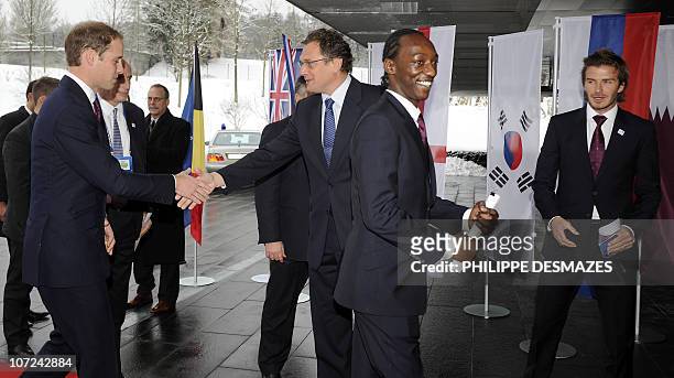 Britain's Prince William shakes hands with FIFA General Secretary Jerome Valcke as England 2018 bid Ambassador Eddie Afekafe and England 2018 bid...