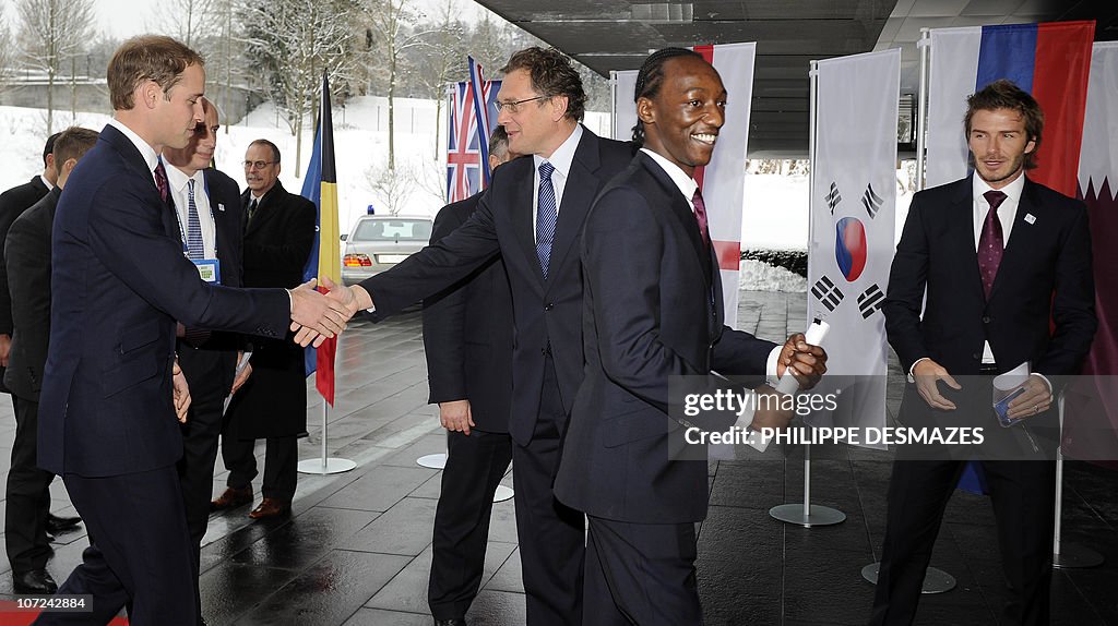 Britain's Prince William (L) shakes hand