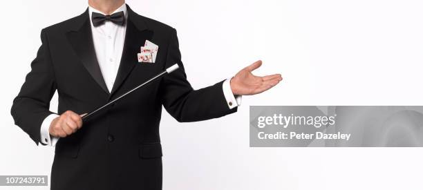 magician with playing cards and wand - magic card trick stock pictures, royalty-free photos & images