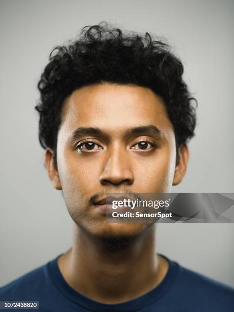 real pakistani man with blank expression - young face serious at camera stock pictures, royalty-free photos & images