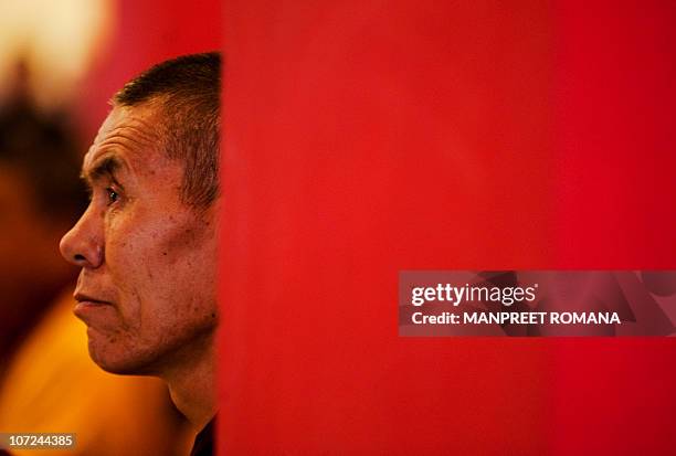 Buddhist monk takes part in prayers during the celebration of 900 years of Karma Kagyu lineage in New Delhi on December 2, 2010. Kamtsang, is the...