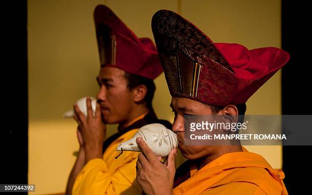Buddhist monks blow conch shells during the celebration of 900 years of Karma Kagyu lineage in New Delhi on December 2, 2010. Kamtsang, is the...