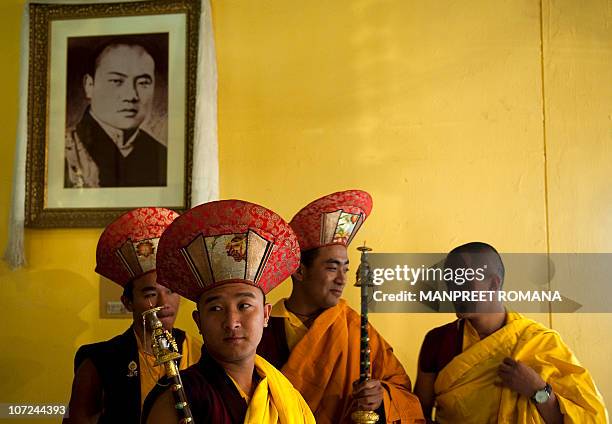 Buddhist monks wait for the start of a celebration of 900 years of Karma Kagyu lineage ceremony to start in New Delhi on December 2, 2010. Kamtsang,...