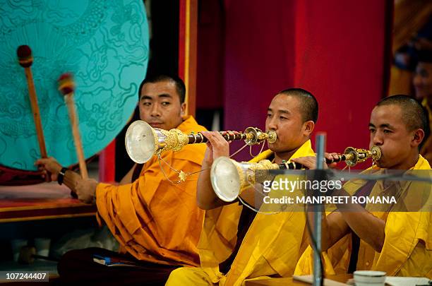 Buddhist monks offer prayers during the celebration of 900 years of Karma Kagyu lineage in New Delhi on December 2, 2010. Kamtsang, is the largest...