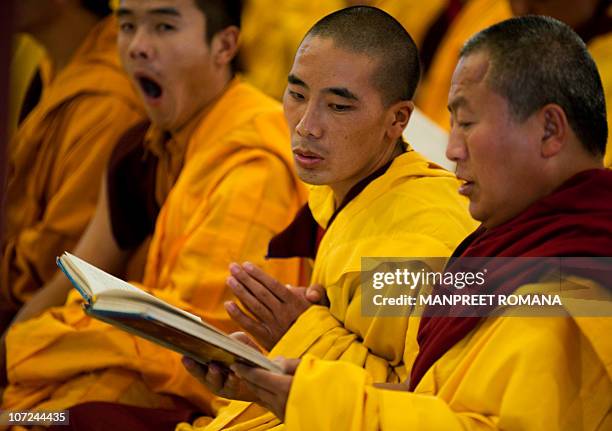 Buddhist monks offer prayers during the celebration of 900 years of Karma Kagyu lineage in New Delhi on December 2, 2010. Kamtsang, is the largest...