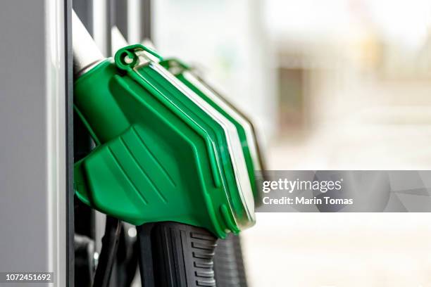 petrol station fuel pump nozzles - unleaded single word stock pictures, royalty-free photos & images