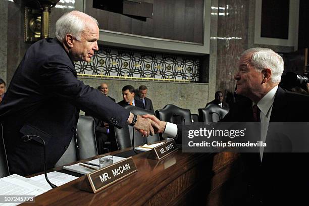 Senate Armed Services Committee ranking member Sen. John McCain greets U.S. Defense Secretary Robert Gates before a hearing about the military's...