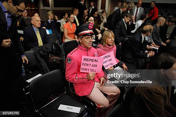 Demonstrators don pink uniforms during a hearing of the Senate Armed Services Committee about the military's "don't ask, don't tell" policy on...