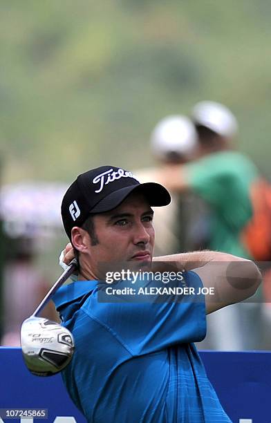 England's Ross Fisher plays a shot on the second hole during day one of the South African Nedbank Golf Challenge in Sun City on December 02, 2010....