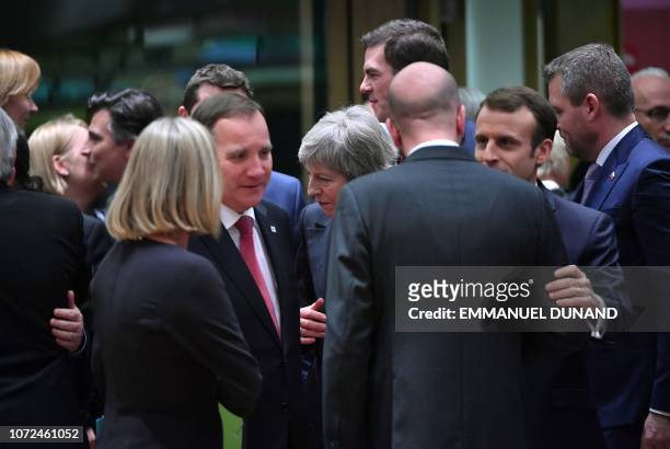 Britain's Prime Minister Theresa May speaks with European leaders as she arrives to attend a European Summit aimed at discussing the Brexit deal, the...