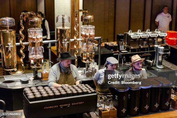 Baristas prepare specialty coffee drinks at an espresso bar during a media preview day at the Starbucks Corp. Reserve Roastery in New York, U.S., on...
