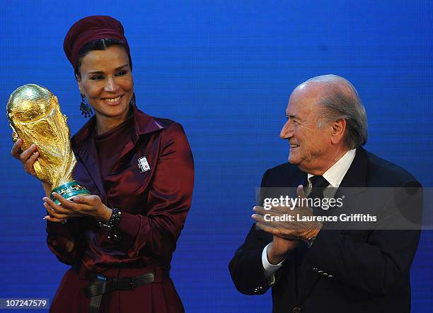 Sheikha Mozah bint Nasser Al Missned is presented with the World Cup Tophy by FIFA President Joseph S Blatter after winning the bid for 2022 during...