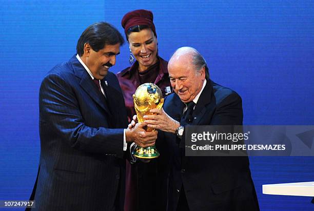 Emir of the State of Qatar Sheikh Hamad bin Khalifa Al-Thani and his wife Sheikha Moza bint Nasser Al-Missned receive the World Cup trophy from Fifa...