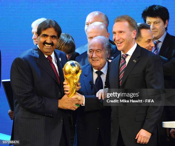 Sheikh Hamad bin Khalifa Al-Thani the Emir of Qatar and Deputy Russia Prime Minister Igor Shuvalov hold the FIFA World Cup trophy with FIFA President...