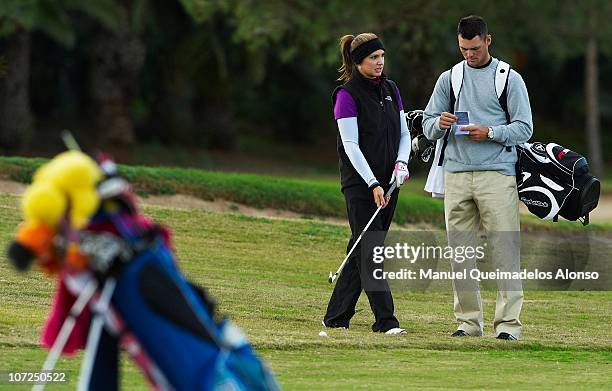 Martin Kaymer of Germany accompanies his girlfriend Allison Micheletti of the United States as she takes part in the Ladies European Tour...