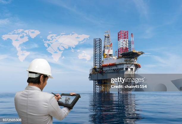 digital transformation with engineer work with tablet for oil and gas industry drilling operation on the platform - oil rig engineers stock pictures, royalty-free photos & images