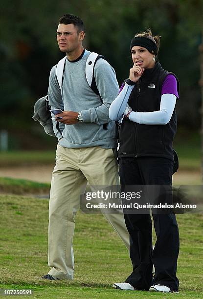 Martin Kaymer of Germany accompanies his girlfriend Allison Micheletti of the United States as she takes part in the Ladies European Tour...