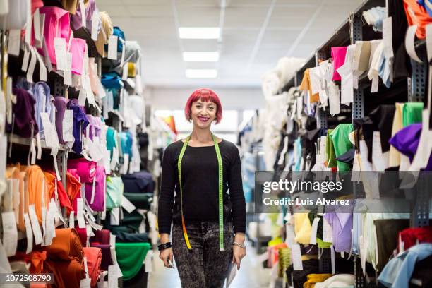 confident female fashion designer at shop - fashion director fotografías e imágenes de stock