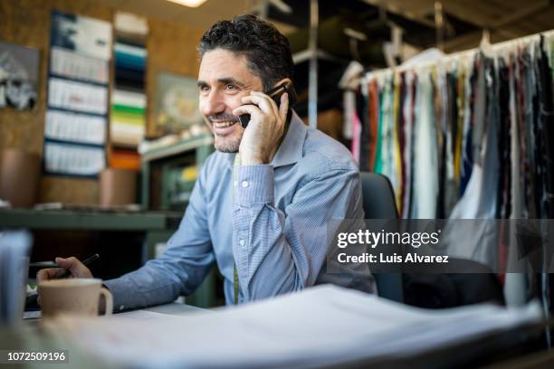 fashion shop owner having telephonic conversation with client. - happy consumer on phone stock pictures, royalty-free photos & images