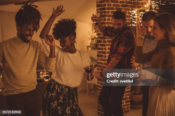friends dancing on new year party - dancing house party stock pictures, royalty-free photos & images