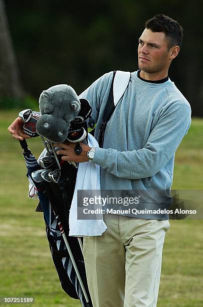 Martin Kaymer of Germany accompanies his girlfriend Allison Micheletti of the United States as she takes part in the Ladies European Tour...