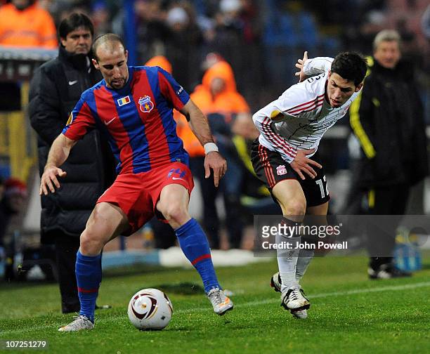 Daniel Pacheco of Liverpool competes with Iasmin Latovlevici of Steau Bucharest during the UEFA Europa League Group K Match between Steaua Bucharest...