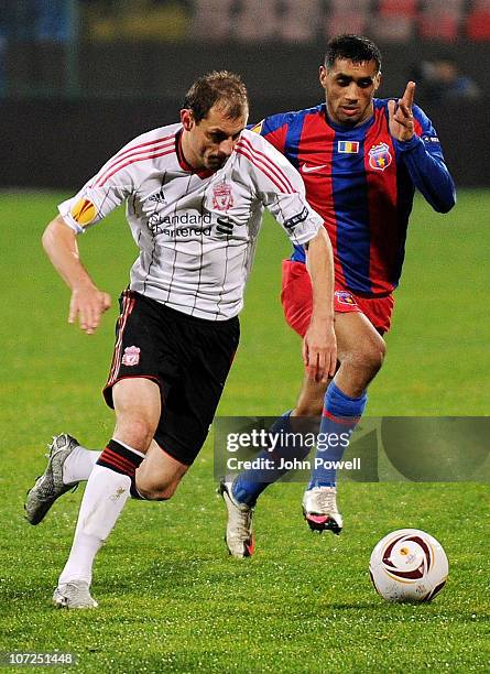 Milan Jovanovic of Liverpool competes with Banel Nicolta of Steau Bucharest during the UEFA Europa League Group K Match between Steaua Bucharest and...