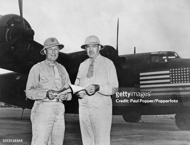 United States Army Air Forces General George Brett pictured on left with Colonel Caleb V Haynes as they stand together in front of a Consolidated...