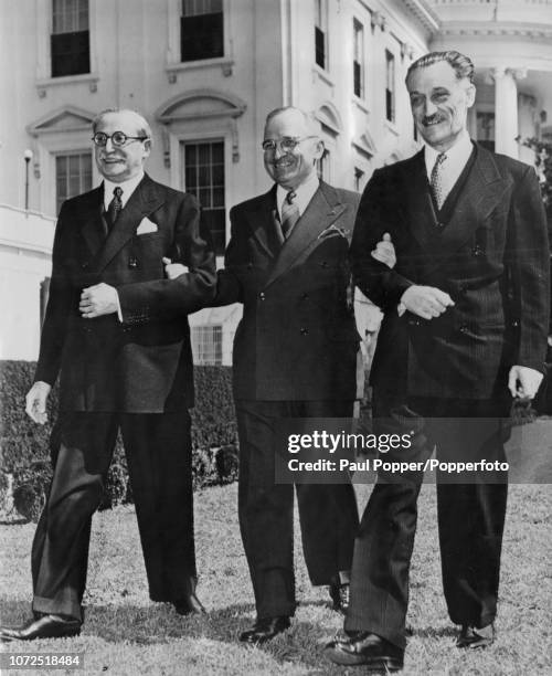 President of the United States Harry S Truman pictured in centre as he escorts French politician Leon Blum on left and French Ambassador to the...