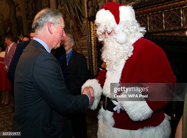 Prince Charles, Princess of Wales, meets a Santa Claus as he attends a reception for the 'Not Forgotten Association' at St. James's Palace State...