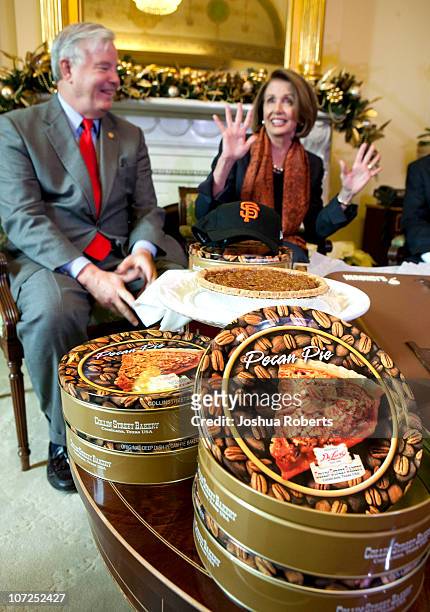 Speaker of the House Speaker Rep. Nancy Pelosi reacts as she receives pecan pies from Rep. Joe Barton to settle a bet after the San Francisco Giants...