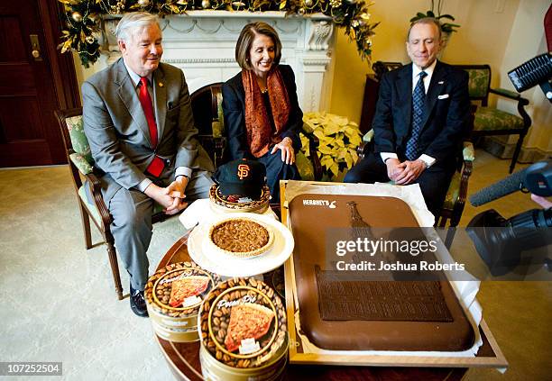 Speaker of the House Speaker Rep. Nancy Pelosi receives pecan pies from Rep. Joe Barton and a giant Hershey bar from Rep. Arlen Specter to settle a...