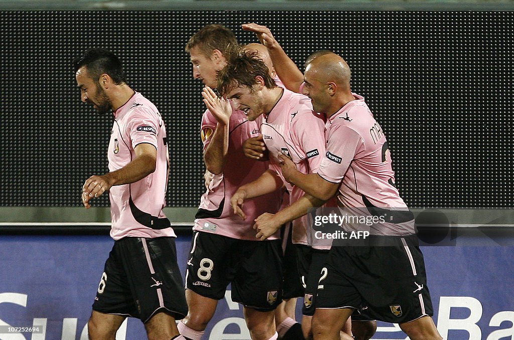 Palermo's midfielder Nicola Rigoni is congratulated by team mates ...