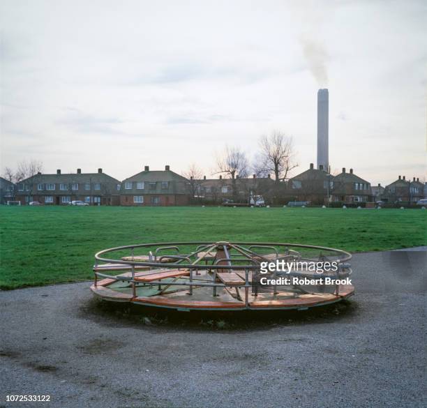 children's play area and industrial chimney - public park playground stock pictures, royalty-free photos & images