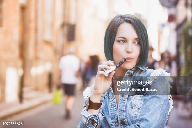 young hipster vape on the street - eastern europe ストックフォトと画像