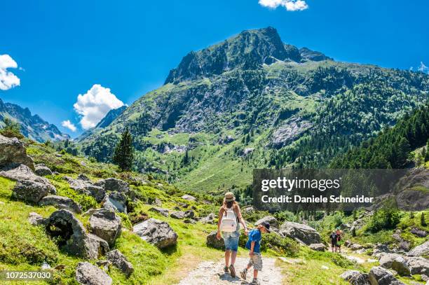 france, pyrenees national park, occitanie region, val d'azun, 6-year-old boy and his mother on a track of the valley of the gave d'arrens (name referring to torrential rivers, in the west side of the pyrenees) - midirock stock pictures, royalty-free photos & images