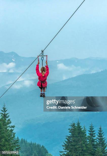 france, pyrenees national park, val d'azun, little girl on a zip-line at the col du soulor (mountain pass) - hautes pyrénées stock pictures, royalty-free photos & images